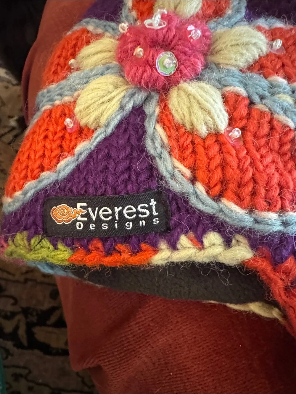 Everest Designs Purple Floral Knit Earflap Hat for Kids with Braided Tassels